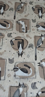 Loneta Gatuna: estampado de gatos en blanco y negro sobre cojines beige, con huellas, espinas de pescado y marcos sobre fondo crudo