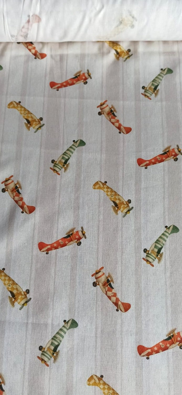 Tela de algodón con aviones vintage rojos, verdes y mostaza sobre fondo de rayas beige