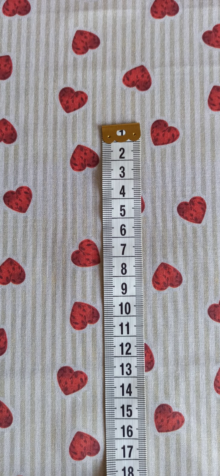 Detalle del estampado de corazones sobre rayas beige