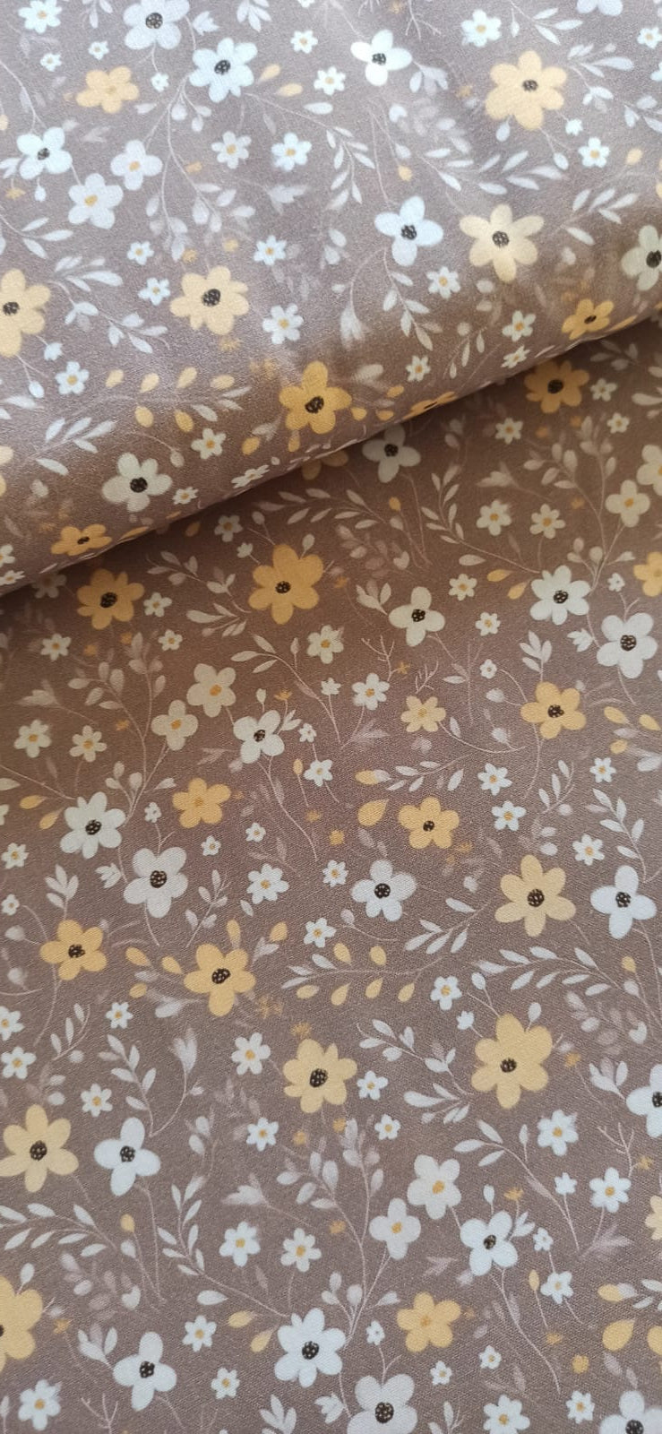 Detalle de flores y hojas sobre algodón marrón topo