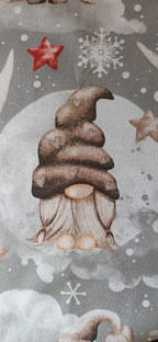 Detalle de gnomo con gorro marrón y estrellas en tela navideña gris