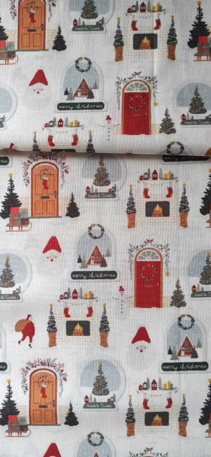 Detalle del estampado navideño de puertas decoradas y chimeneas con calcetines sobre algodón blanco.
